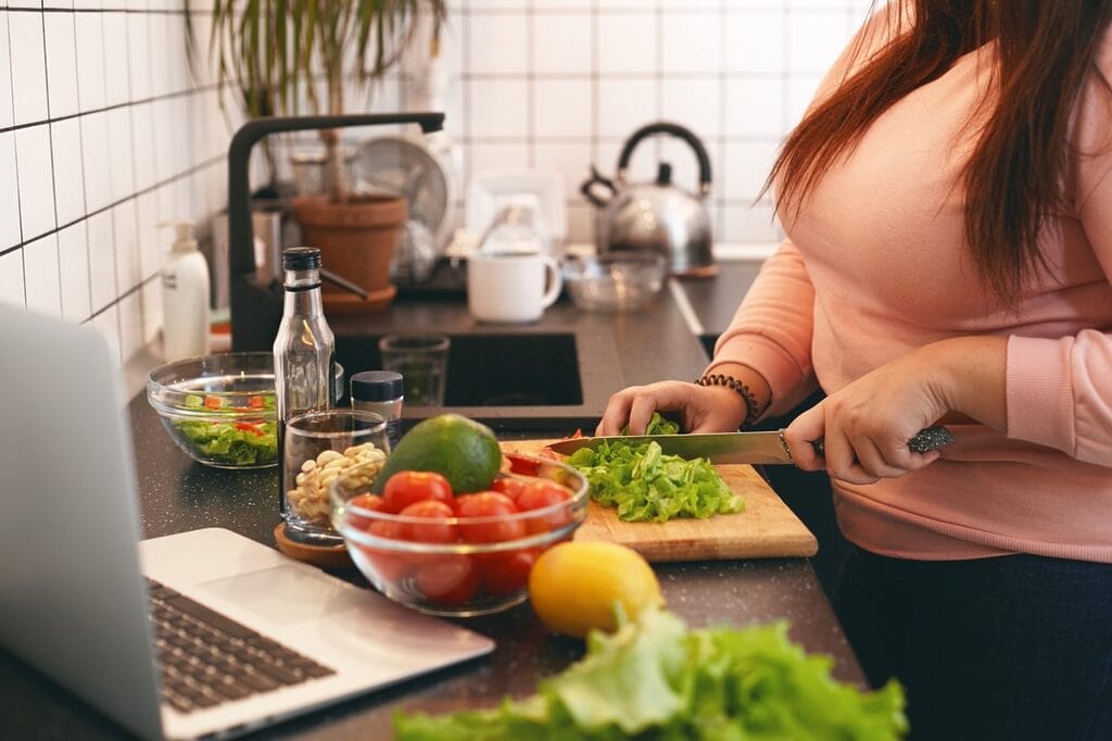 Person preparing balanced meal with fresh ingredients for recovery