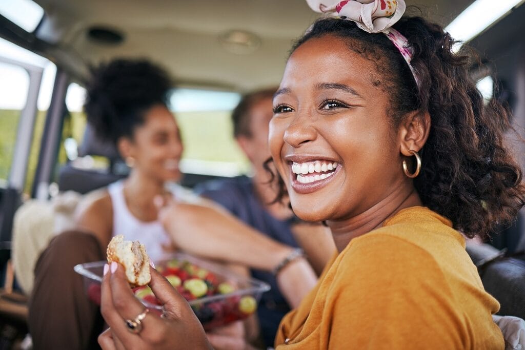Family eating healthy meals together in car maintaining routine
