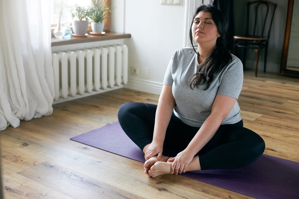 Woman practicing yoga meditation for recovery stress management